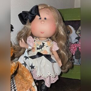 Adorable Mia Doll with Black Bow and Patterned Dress